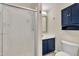 Cozy bathroom features shower with glass doors and blue vanity with matching blue wall cabinet at 3116 Henslowe Dr, Raleigh, NC 27603