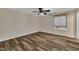 Bright bedroom with hardwood floors, ceiling fan and large window at 3116 Henslowe Dr, Raleigh, NC 27603