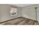 Bright bedroom with wood floors, window with shade, and white shelving at 3116 Henslowe Dr, Raleigh, NC 27603