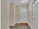 Bright foyer with neutral walls, ceramic tile flooring, and a classic front door at 3116 Henslowe Dr, Raleigh, NC 27603