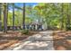 Traditional single-story house with blue shutters, a long driveway and mature trees at 3116 Henslowe Dr, Raleigh, NC 27603