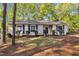 Charming single-story home with blue shutters surrounded by lush greenery and mature trees at 3116 Henslowe Dr, Raleigh, NC 27603