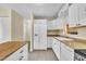 Clean, white kitchen with stainless appliances and butcher block island at 3116 Henslowe Dr, Raleigh, NC 27603