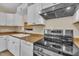 Bright kitchen featuring updated stainless steel appliances and stone accent wall in view at 3116 Henslowe Dr, Raleigh, NC 27603