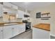 Bright kitchen featuring white cabinets, countertops, and stainless steel appliances at 3116 Henslowe Dr, Raleigh, NC 27603