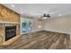 Cozy living room with a stone fireplace, wood floors, and french doors to outdoor deck at 3116 Henslowe Dr, Raleigh, NC 27603