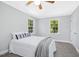 Cozy bedroom featuring neutral walls and carpet, bright windows, and a ceiling fan at 3117 Woodgreen Dr, Raleigh, NC 27607