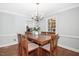 Bright dining room with a wood table, chandelier, and natural light at 3117 Woodgreen Dr, Raleigh, NC 27607