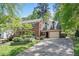 Beautiful brick house with a two-car garage, concrete driveway, and manicured landscaping at 3117 Woodgreen Dr, Raleigh, NC 27607