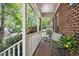 Inviting brick porch with seating offers a cozy outdoor space with neighborhood views at 3117 Woodgreen Dr, Raleigh, NC 27607