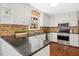 Well-maintained kitchen with granite countertops, stainless steel appliances, and tile backsplash at 3117 Woodgreen Dr, Raleigh, NC 27607