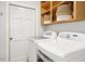 Laundry room featuring full-size washing machine and dryer with storage at 3117 Woodgreen Dr, Raleigh, NC 27607