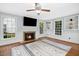 Bright living room with fireplace, built-in shelves, hardwood floors, and ample natural light at 3117 Woodgreen Dr, Raleigh, NC 27607