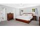 Bright main bedroom with a ceiling fan, two windows, and an ensuite at 3117 Woodgreen Dr, Raleigh, NC 27607