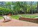Brick patio with cushioned chair and decorative garden planters at 3117 Woodgreen Dr, Raleigh, NC 27607