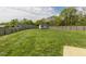 Large, grassy backyard featuring a storage shed and a well-maintained fence at 312 Loon Ct, Graham, NC 27253