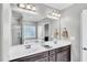 Bathroom with double sink vanity, large mirror, and a separate tub and shower at 312 Loon Ct, Graham, NC 27253