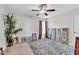 Bedroom featuring a ceiling fan, decorative wall art, and large windows at 312 Loon Ct, Graham, NC 27253