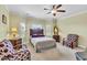 Spacious bedroom with large bed, ceiling fan and a comfy seating area at 312 Loon Ct, Graham, NC 27253