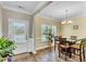 Bright dining room featuring wood floors, a chandelier, and a view of the outdoors at 312 Loon Ct, Graham, NC 27253