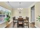 Dining room with a wooden table and chairs illuminated by an elegant chandelier at 312 Loon Ct, Graham, NC 27253