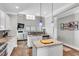 Contemporary kitchen featuring granite countertops, white cabinets, an island, and stainless steel appliances at 312 Loon Ct, Graham, NC 27253