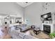 Spacious living room with hardwood floors, a fireplace, and an open view into the kitchen area at 312 Loon Ct, Graham, NC 27253