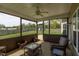 Relaxing screened porch with wicker furniture and views of the backyard at 312 Loon Ct, Graham, NC 27253