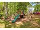 Backyard featuring mature trees, a playset, swings, a slide, and a hammock at 3312 Shannon Cir, Apex, NC 27539