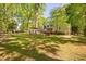 Wide shot of the spacious backyard featuring mature trees and established features at 3312 Shannon Cir, Apex, NC 27539