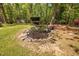 Scenic backyard with a decorative dry pond, swing set, storage shed, and mature landscaping at 3312 Shannon Cir, Apex, NC 27539