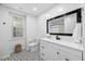 Bright bathroom features black and white patterned tile floor and a modern vanity with a black framed mirror at 3312 Shannon Cir, Apex, NC 27539