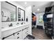 A bathroom featuring double sinks with black hardware, a walk-in closet, and wood-look flooring at 3312 Shannon Cir, Apex, NC 27539