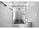 An updated bathroom with black hardware and white tile in the shower and on the walls at 3312 Shannon Cir, Apex, NC 27539