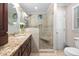 Bathroom showcasing a granite vanity, sink, and a beautifully tiled walk-in shower with a built-in seat at 3312 Shannon Cir, Apex, NC 27539