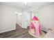 Cozy bedroom featuring wood floors, a window, and a playful pink play tent for children at 3312 Shannon Cir, Apex, NC 27539