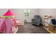 Bedroom with hardwood floors, rocking chair, and a cute play tent at 3312 Shannon Cir, Apex, NC 27539