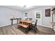 Bright dining room featuring a wood table with a modern light fixture at 3312 Shannon Cir, Apex, NC 27539