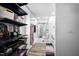 Hallway leading to a bright bathroom with a walk-in shower, white vanity, and plenty of storage at 3312 Shannon Cir, Apex, NC 27539