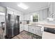 Bright kitchen with stainless steel refrigerator and white appliances at 3312 Shannon Cir, Apex, NC 27539