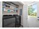 Updated Laundry room including front load washer and dryer with utility sink at 3312 Shannon Cir, Apex, NC 27539