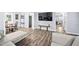 Comfortable living room with wood-look floors flows seamlessly into dining and other living areas at 3312 Shannon Cir, Apex, NC 27539