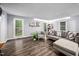 Comfortable living room with wood-look floors, plenty of natural light, and grey, modern furniture at 3312 Shannon Cir, Apex, NC 27539