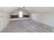A finished attic has neutral carpet, a window seat and is painted a modern neutral color at 3317 E Jameson Rd, Raleigh, NC 27604