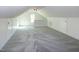 A finished attic with neutral carpet is painted a modern neutral color at 3317 E Jameson Rd, Raleigh, NC 27604