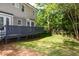 Inviting backyard with a private deck, complemented by lush greenery and mature trees at 3317 E Jameson Rd, Raleigh, NC 27604