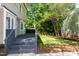 Inviting backyard with a private deck, complemented by lush greenery and mature trees at 3317 E Jameson Rd, Raleigh, NC 27604