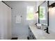 Double vanity bathroom with a shower and modern lighting at 3317 E Jameson Rd, Raleigh, NC 27604