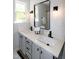 Double vanity bathroom with a shower and modern lighting at 3317 E Jameson Rd, Raleigh, NC 27604