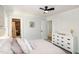 Neutral bedroom with ceiling fan, ensuite bathroom, and large dresser at 3317 E Jameson Rd, Raleigh, NC 27604
